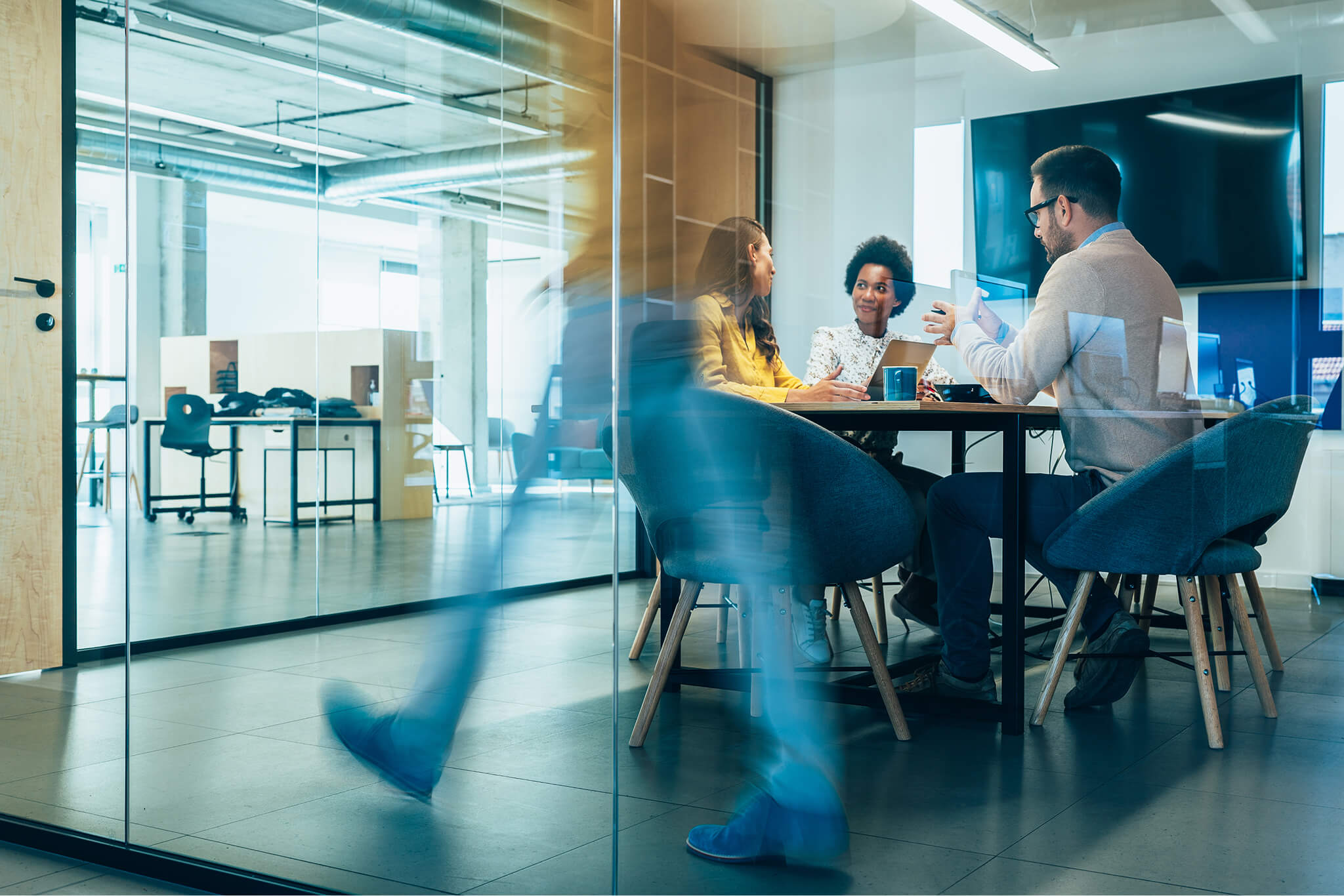 People moving through a modern glass office